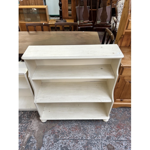 102 - Two white painted bookcases, one three tier waterfall - approx. 99cm high x 94cm wide x 37cm deep an... 