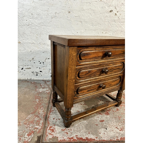 104 - An oak chest of drawers - approx. 56cm high x 56cm wide x 29cm deep