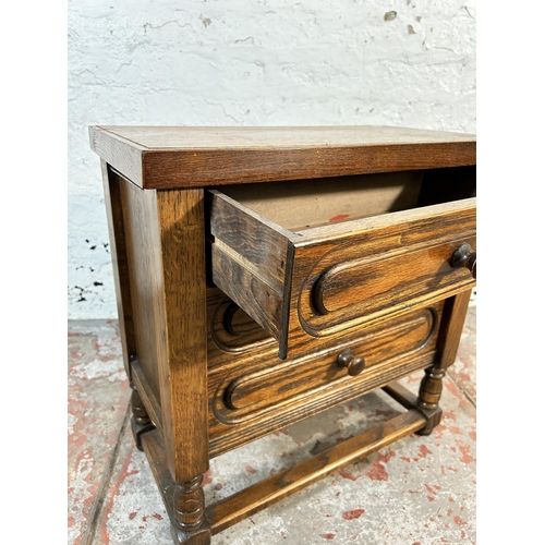 104 - An oak chest of drawers - approx. 56cm high x 56cm wide x 29cm deep