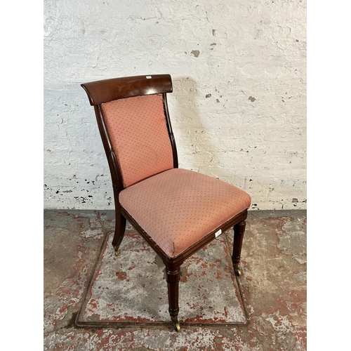 106 - A 19th century mahogany and pink fabric upholstered occasional chair on brass castors