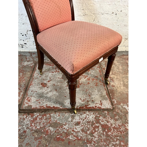 106 - A 19th century mahogany and pink fabric upholstered occasional chair on brass castors