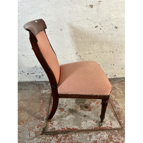 106 - A 19th century mahogany and pink fabric upholstered occasional chair on brass castors