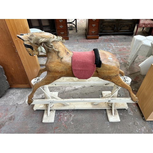 110 - A carved pine rocking horse on white painted stand - approx. 113cm high x 52cm wide x 136cm long