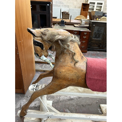 110 - A carved pine rocking horse on white painted stand - approx. 113cm high x 52cm wide x 136cm long