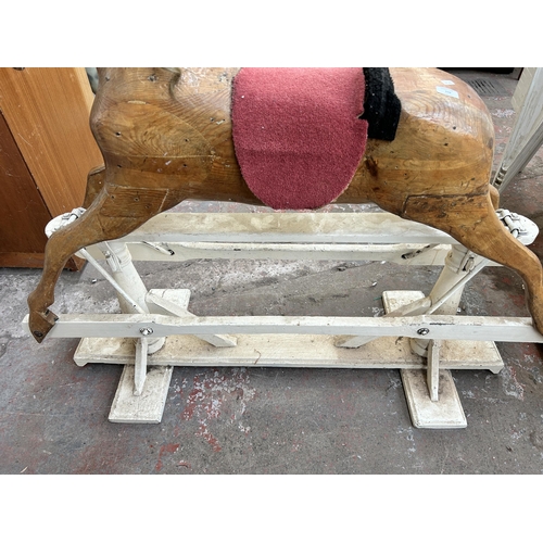 110 - A carved pine rocking horse on white painted stand - approx. 113cm high x 52cm wide x 136cm long