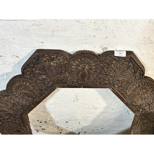 111 - An Indian carved teak octagonal folding travel table