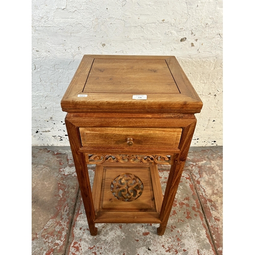 130 - A Chinese carved hardwood two tier side table