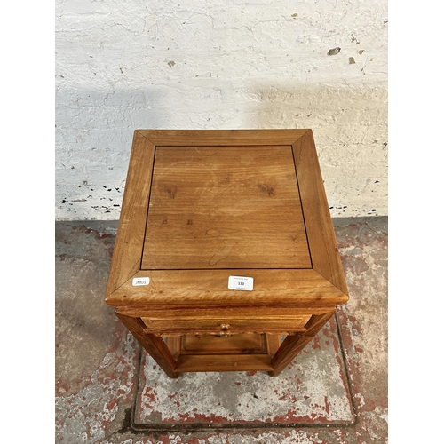 130 - A Chinese carved hardwood two tier side table