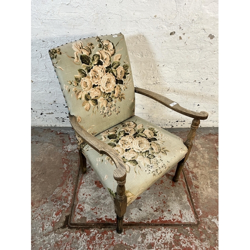 131 - A mid 20th century oak and floral upholstered armchair