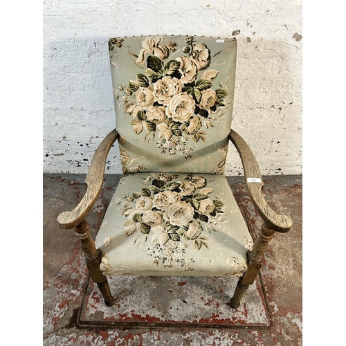 131 - A mid 20th century oak and floral upholstered armchair