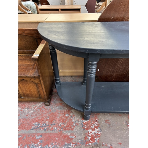 133 - A modern blue painted half moon two tier console table - approx. 85cm high x 180cm wide x 48cm deep