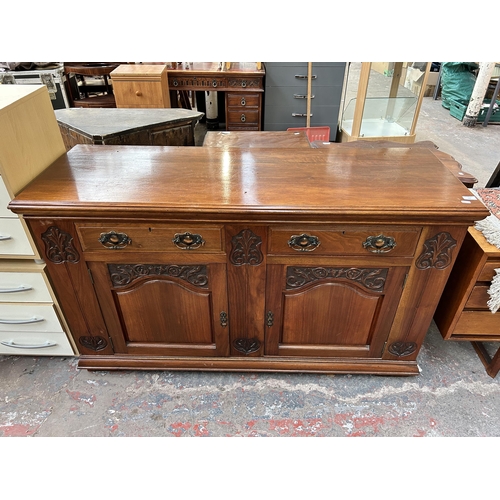 143 - A late Victorian/Edwardian carved walnut sideboard - approx. 87cm high x 150cm wide x 53cm deep