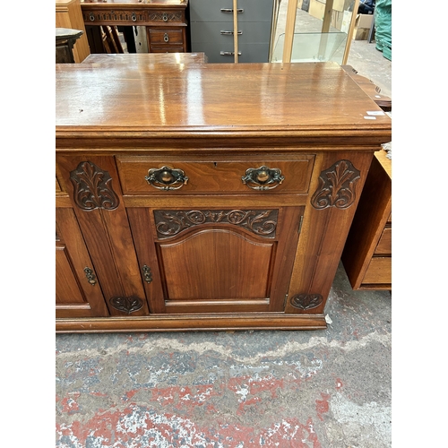 143 - A late Victorian/Edwardian carved walnut sideboard - approx. 87cm high x 150cm wide x 53cm deep