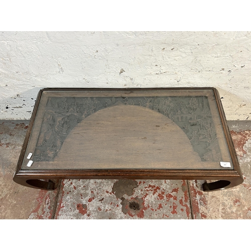 167 - A Chinese carved hardwood coffee table with glass insert - approx. 36cm high x 47cm wide x 104cm lon... 