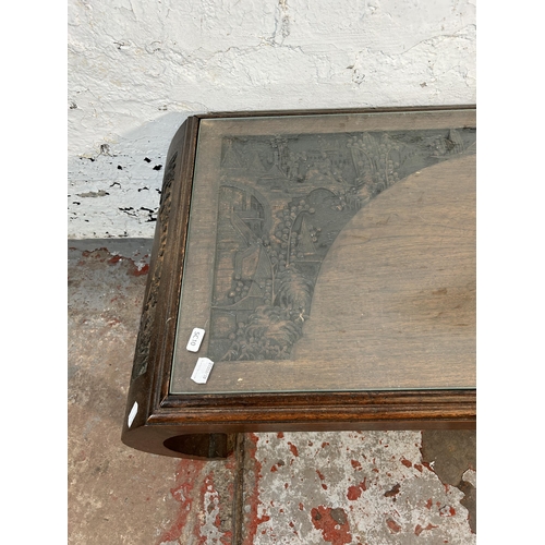 167 - A Chinese carved hardwood coffee table with glass insert - approx. 36cm high x 47cm wide x 104cm lon... 