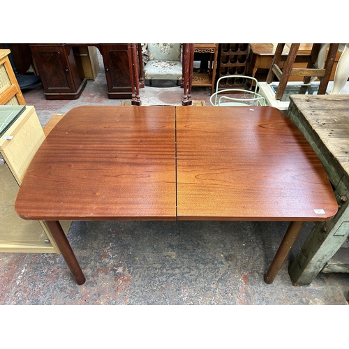 168 - A mid 20th century teak extending dining table