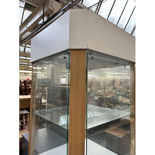 178 - A modern beech effect and glass display cabinet - approx. 216cm high x 70cm wide x 70cm deep