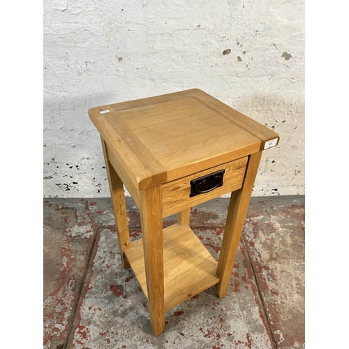 181 - A modern solid oak side table - approx. 75cm high x 36cm wide x 36cm deep