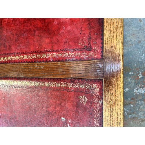 184 - A carved oak and red leather pedestal desk - approx. 80cm high x 128cm wide x 61cm deep