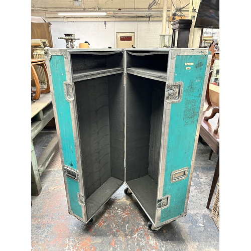 188 - A turquoise and metal flight case on castors - approx. 148cm high x 62cm wide x 51cm deep