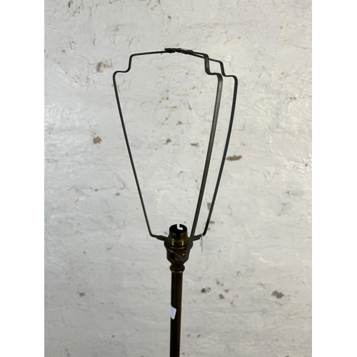 207 - A mid 20th century teak and brass standard lamp - approx. 128cm high