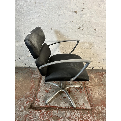 213 - A black vinyl and brushed steel height adjustable salon chair