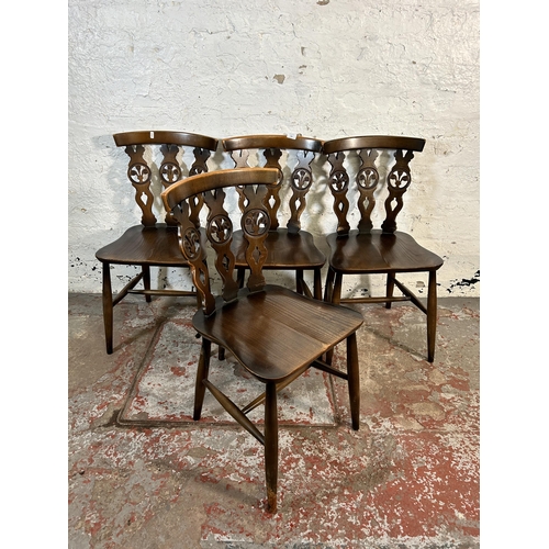 220 - Four mid 20th century Ercol elm and beech Fleur De Lys dining chairs