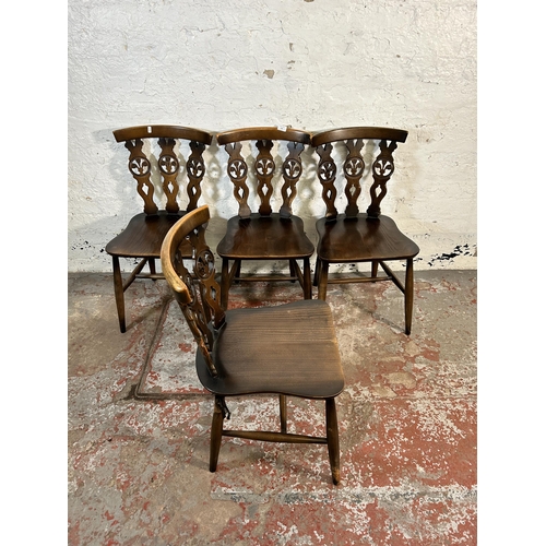 220 - Four mid 20th century Ercol elm and beech Fleur De Lys dining chairs