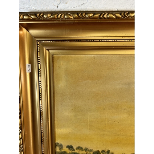 230 - An early 20th century gilt framed oil on canvas of a winter farming scene signed A.P. and dated 1923... 