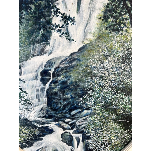 243 - A mid 20th century framed oil on board of a waterfall, signed lower right and dated 1973 - approx. 6... 