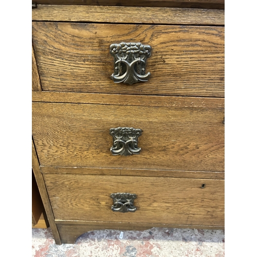 4 - An Arts & Crafts oak bureau bookcase with two upper leaded glazed doors, three internal shelves, fal... 