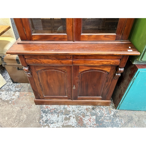 42 - A Victorian mahogany bookcase with two upper glazed doors, two internal shelves, two lower drawers a... 