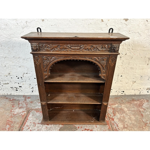 57 - A 19th century Gothic Revival carved oak wall mountable three tier shelving unit - approx. 70cm high... 