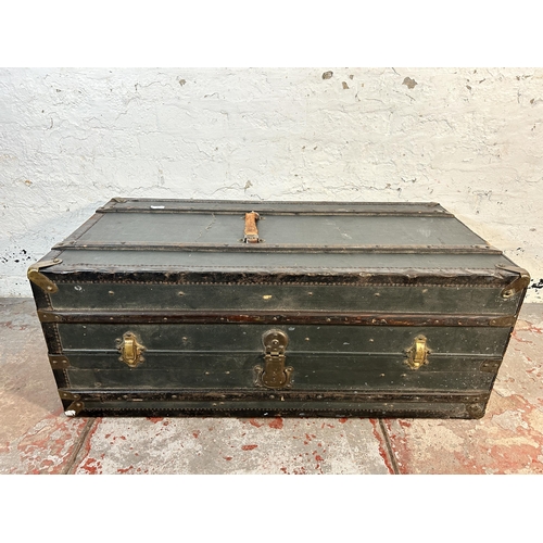 61 - An early 20th century wooden banded and blue canvas travel trunk with fitted interior, original brow... 