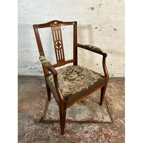 63 - An early 20th century oak carver armchair with tapestry upholstered seat