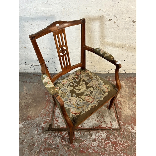 63 - An early 20th century oak carver armchair with tapestry upholstered seat