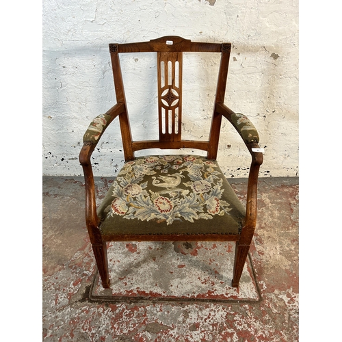 63 - An early 20th century oak carver armchair with tapestry upholstered seat