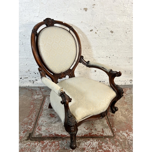 64 - A 19th century carved mahogany and upholstered armchair