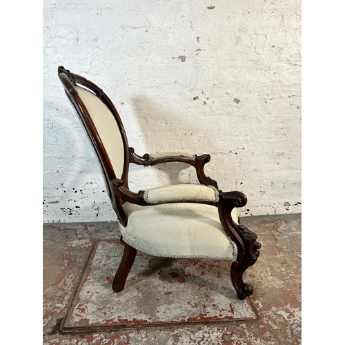 64 - A 19th century carved mahogany and upholstered armchair