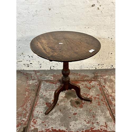 69 - A 19th century oak tilt top tripod side table - approx. 61.5cm high x 47cm diameter