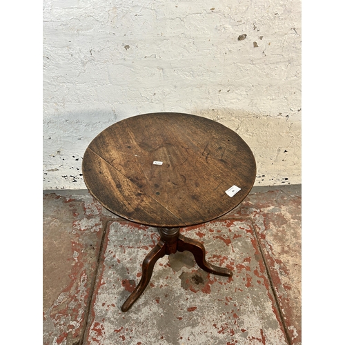 69 - A 19th century oak tilt top tripod side table - approx. 61.5cm high x 47cm diameter