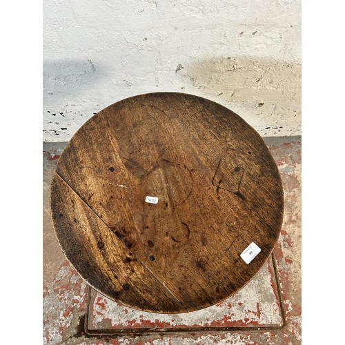 69 - A 19th century oak tilt top tripod side table - approx. 61.5cm high x 47cm diameter