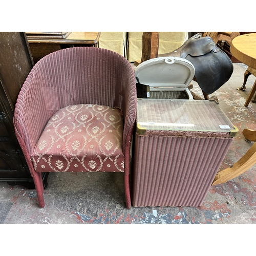 73 - Three pieces of mid 20th century Lloyd Loom furniture, one tub chair, one pink linen basket and one ... 