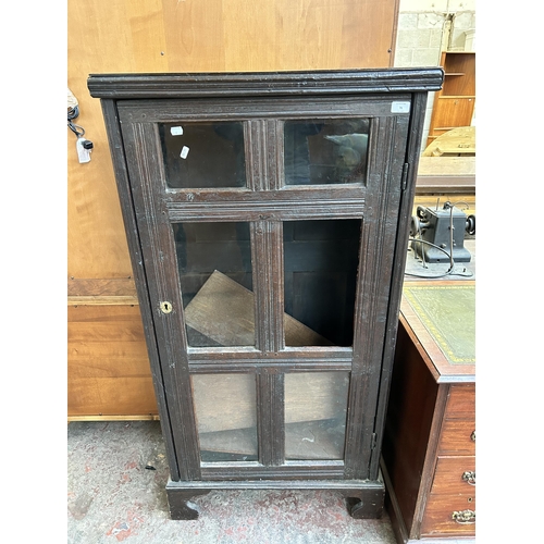 76 - A Georgian oak bookcase with single glazed door on bracket supports - 141cm high x 73cm wide x 31cm ... 