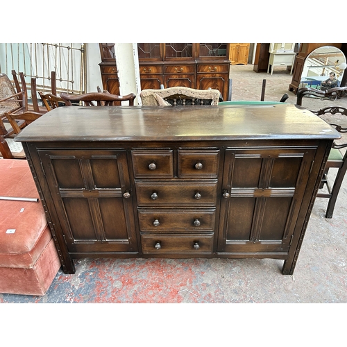 82 - An Ercol Old Colonial dark elm and beech sideboard - approx. 90cm high x 146cm wide x 50cm deep