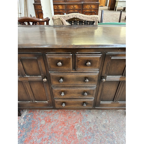 82 - An Ercol Old Colonial dark elm and beech sideboard - approx. 90cm high x 146cm wide x 50cm deep