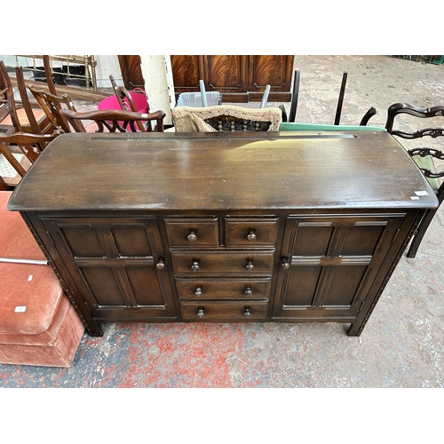 82 - An Ercol Old Colonial dark elm and beech sideboard - approx. 90cm high x 146cm wide x 50cm deep