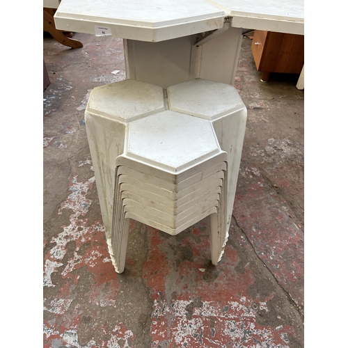 91 - A 1980s Jasp for Hexagon Designs white plastic outdoor dining table and eight stacking stools