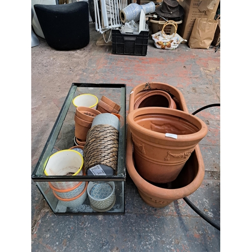 1105 - A collection of terracotta and plastic garden planters