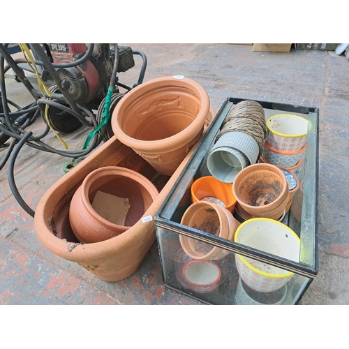 1105 - A collection of terracotta and plastic garden planters